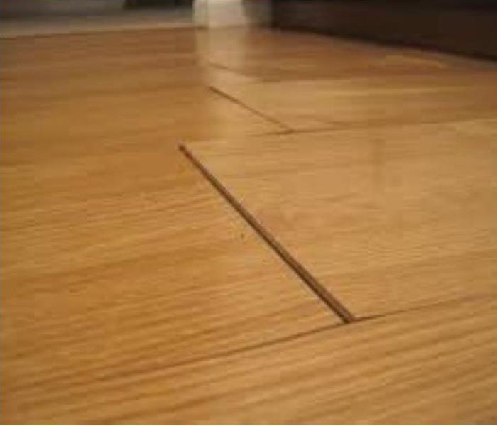 Hardwood floor with warped panels as a result of water damage