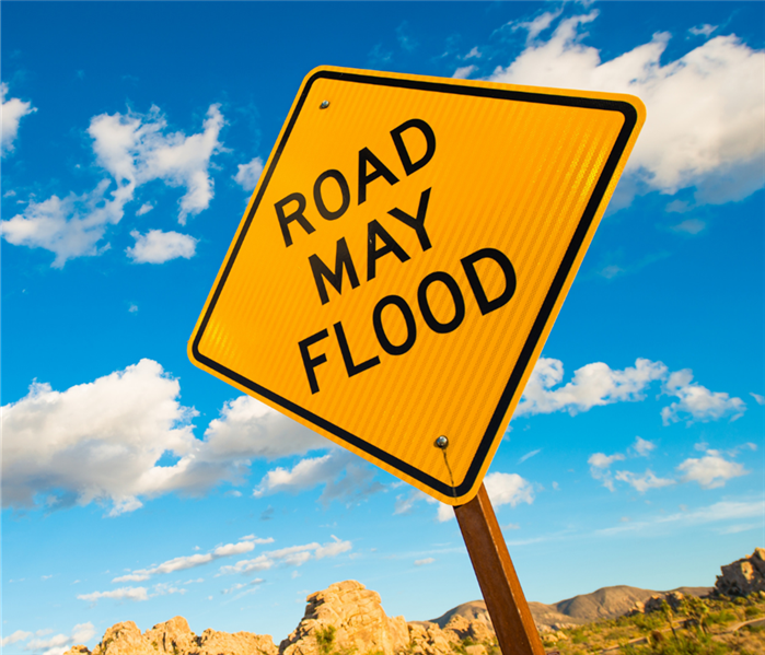 A yellow sign reads "Road May Flood"
