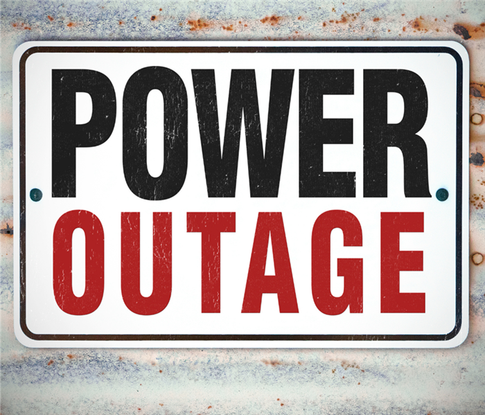 A sign on a rusted wall says "Power Outage."