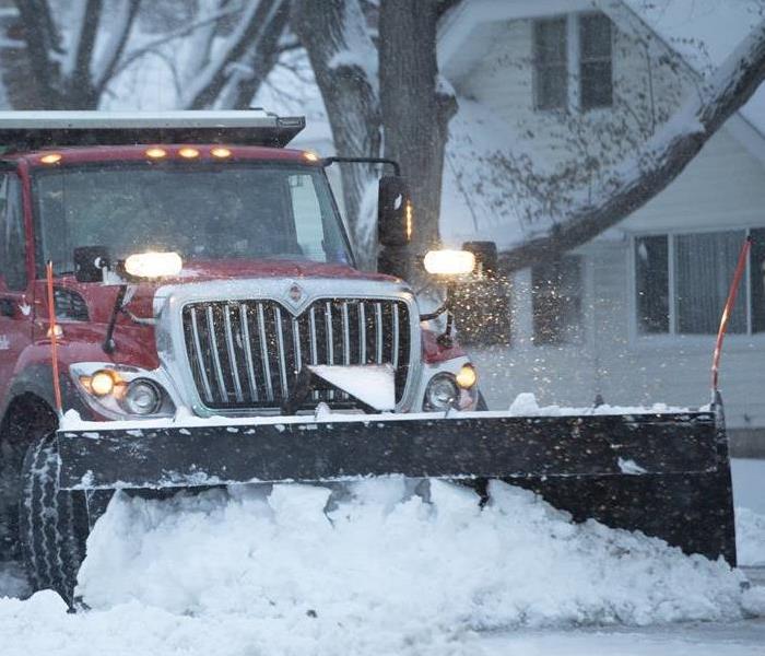 image of snowplow truck clearing off roads during a winter storm