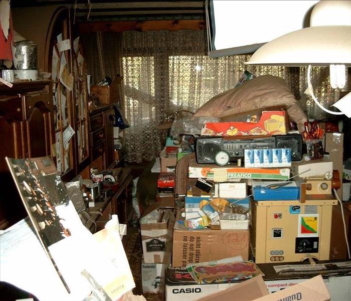image of a room after hoarding has taken place; content visible everywhere